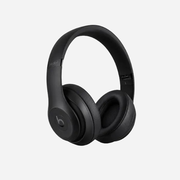 Black Beats Studio3 wireless over-ear headphones on a light gray background.