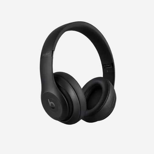 Black Beats Studio3 wireless over-ear headphones on a light gray background.